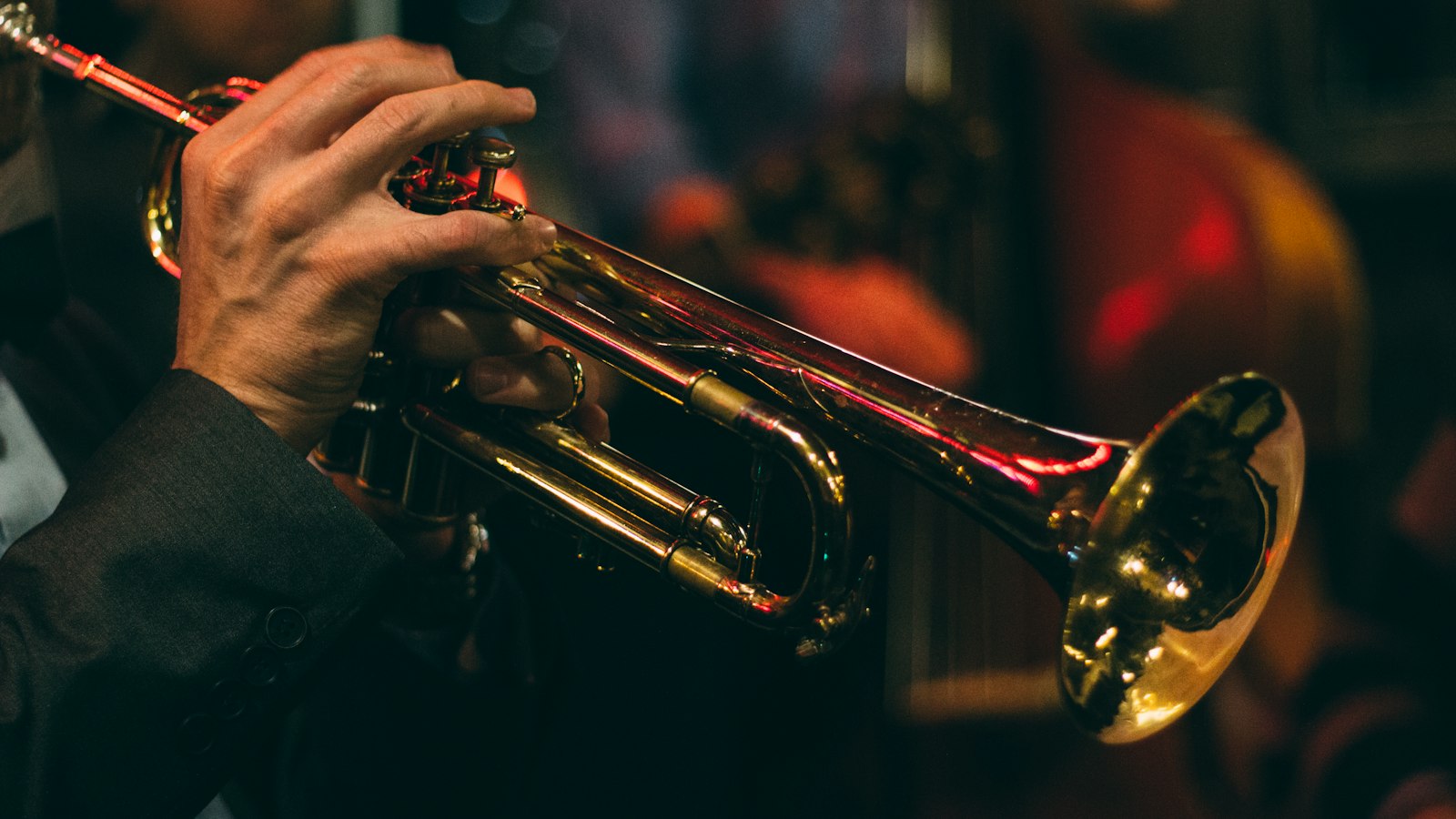 Trumpet player performing on stage at night