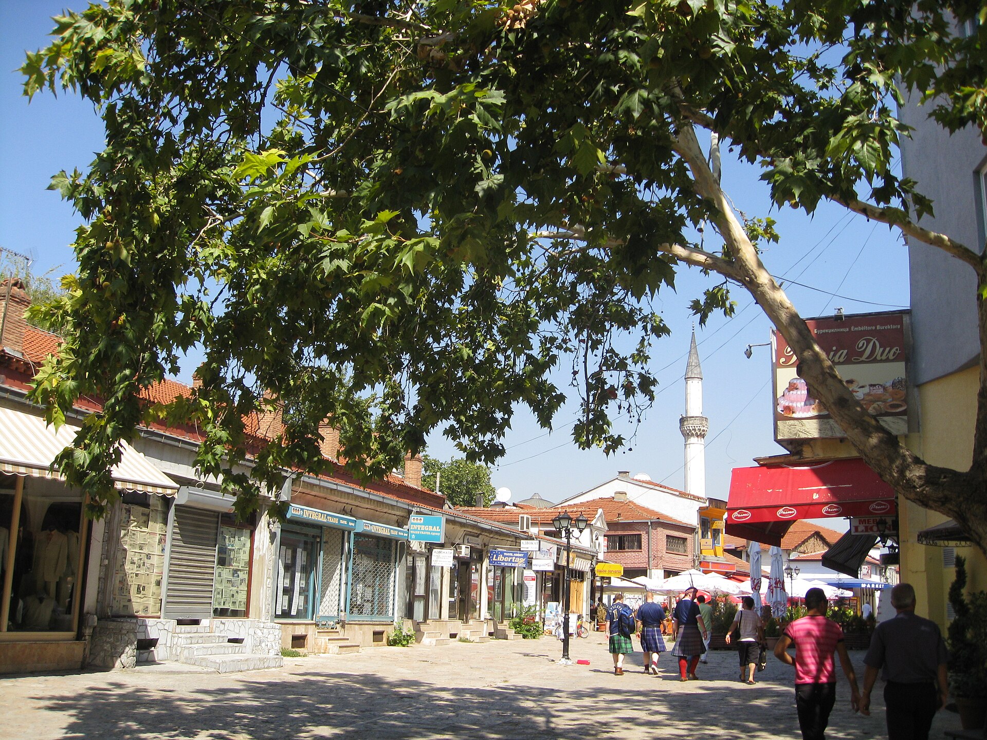 A street in Skopje Old Bazaar with shops and a minaret