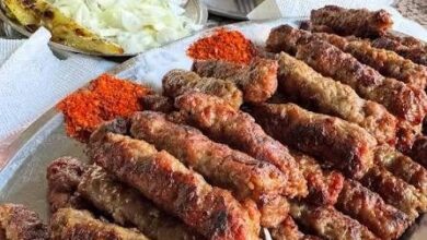 A plate of kebapi in Skopje with flatbread, onion and kajmak